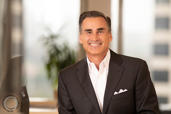 High-impact business headshot focusing on approachable professional authority.